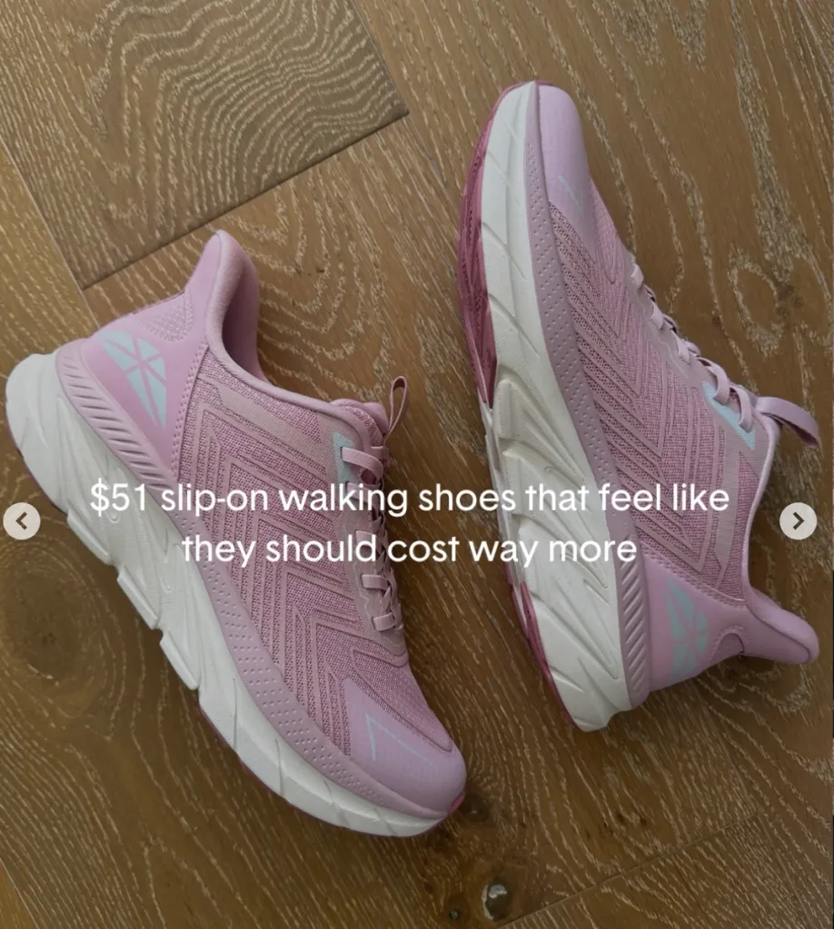 Two pink and white slip-on walking shoes on a wooden floor with text "$51 slip-on walking shoes that feel like they should cost way more".